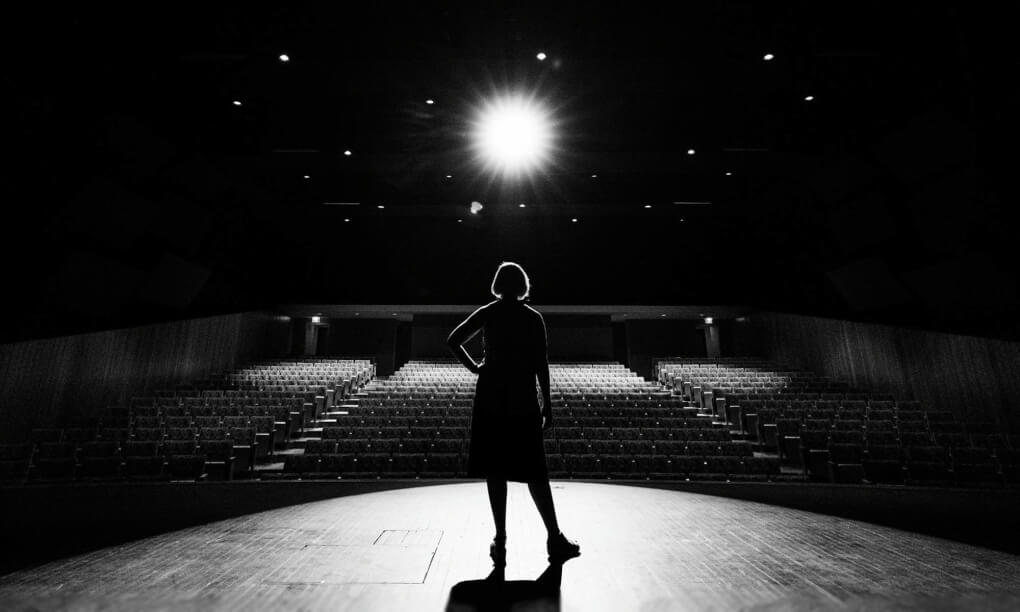 Professor stands in an empty auditorium